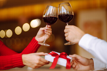 Clinking glasses with red wine. Romantic dinner. Valentines day, romantic date and holidays concept.