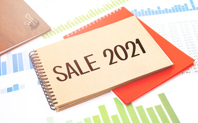 Notepad with text sale 2021. Diagram, red notepad and white background