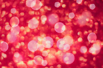 Abstract defocused red background for holidays. Festive Valentine's Day and Christmas background with red boke lights. Red blurred greeting card.