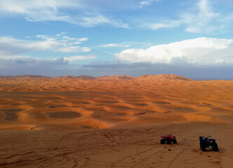 Fototapeta na wymiar View of the Sahara desert with quads and camels