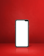 Mobile phone on red office desk background