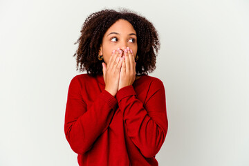 Young african american mixed race woman isolated thoughtful looking to a copy space covering mouth with hand.