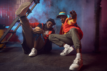 Serious rappers with gold jewelry poses in studio