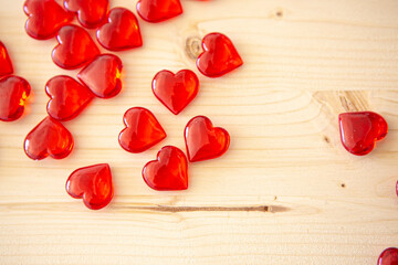 small red hearts on wooden background