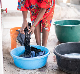African nice woman hand washing laundry outdoors