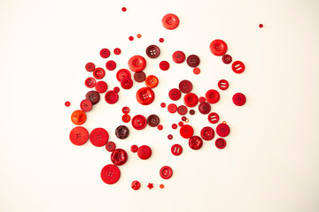 group of red buttons of different sizes on white background