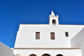 Fototapeta premium Ibiza, Spain - January 17, 2021: Ibiza San Miguel Sant Miquel de Balansat white Mediterranean church on a sunny day..