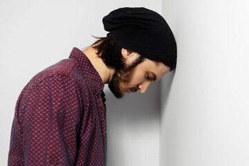 Studio portrait of sad guy on white background.