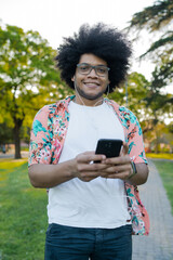 Young man using his mobile phone outdoors.