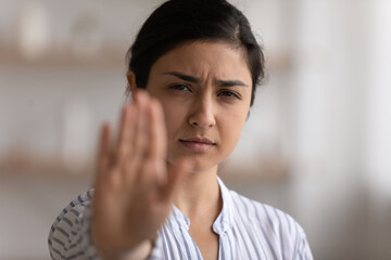 I say enough. Portrait of desperate indian woman showing stop gesture to any manifestations of...