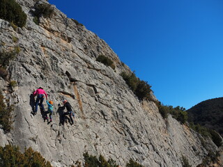 Fototapeta na wymiar family climbing in a mountain rock