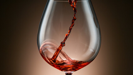 Fototapeta na wymiar Pouring red wine into the glass against light brown background