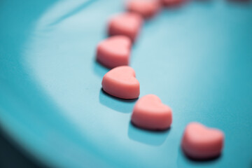 Obraz na płótnie Canvas Pink hearts on a blue pastel background. Valentine```s day concept