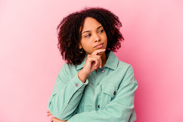 Young african american mixed race woman isolated looking sideways with doubtful and skeptical expression.