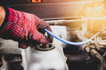 The mechanic is opening oxygen sensor O2 in the exhaust pipe for calculating the ingredients in the engine system , automotive part concept - obrazy, fototapety, plakaty