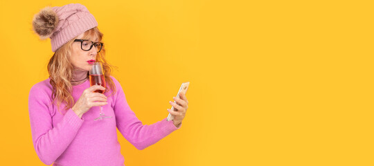 woman with mobile phone and glass of wine isolated