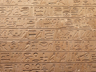 Egyptian hieroglyphs on a stone wall. The language of an ancient civilization.