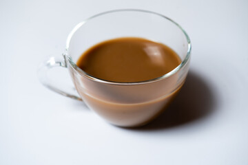 Clear glass of white coffee on white background