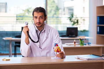 Young male doctor cardiologist working in the clinic