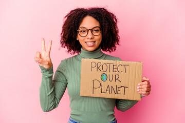 Young african american mixed race woman holding an protect our planet cardboard showing number two with fingers.