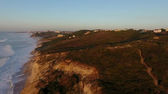 Drone flies next to the Basque Coast in Bidart, France. Golden Hour shows its light across the Basque cliffs.