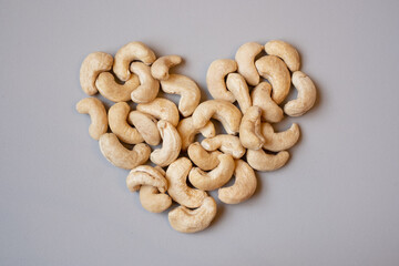 Cashew nuts or cashews in heart shape. Love healthy eating.