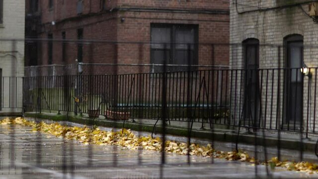 Grimy snowfall gently tumbling down over a Brooklyn Alley in New York city - Medium static shot