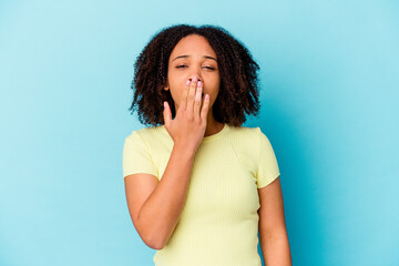 Young african american mixed race woman isolated yawning showing a tired gesture covering mouth with hand.