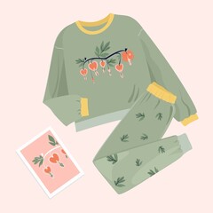 Green pants and a sweatshirt with a stylized Bleeding heart flower. Trendy outfit isolated illustrations. Unisex apparel on a soft background top-down view.
