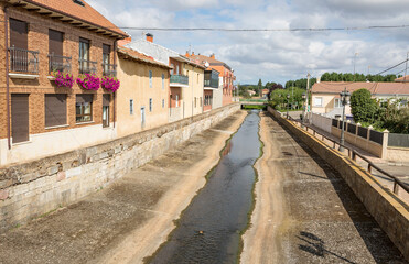 Fototapeta na wymiar watercourse Canal in Hospital de Orbigo town, province of Leon, Castile and Leon, Spain