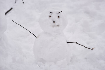 dancing snowman with a sly face in the park. winter entertainment