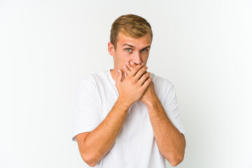 Young caucasian handsome man covering mouth with hands looking worried.