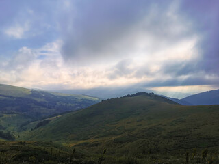 Morning sunrise, and sunrays trought mist in the mountains.