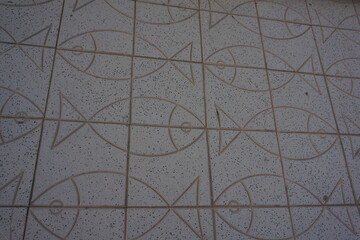 A high angle shot of a tiled floor with fish patterns