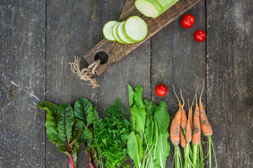 Fresh vegetables with leaves on the old wooden table. Country style. High quality photo