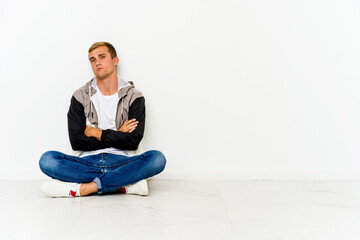 Young caucasian man sitting on the floor who is bored, fatigued and need a relax day.