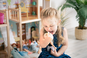 Little girl shouting at a doll