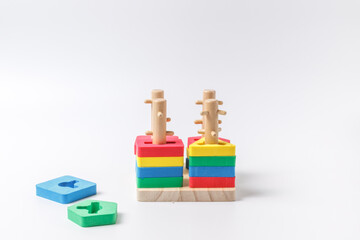 Children's wooden educational toy. Sorter with different color details. Close-up on a white background