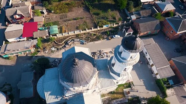 Aerial view of a christian cathedral with bell tower and domes.