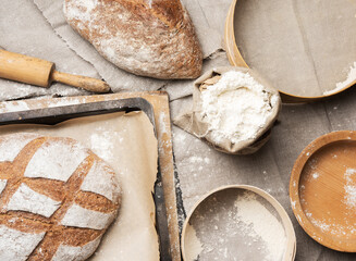 bread and  white wheat flour in a bag, wooden rock and plate