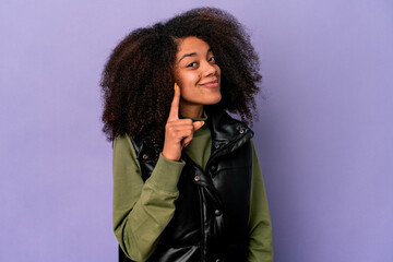 Young african american curly woman isolated on purple background showing number one with finger.
