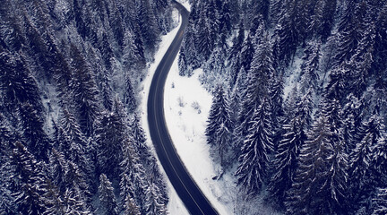 Mountain road in the winter forest. Dolomites Alps Italy.