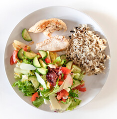 Wild rice, chicken breast salad plate with healthy food.