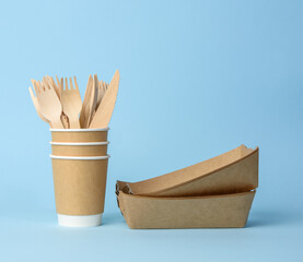 brown paper cup, plates on a blue background. Plastic rejection concept