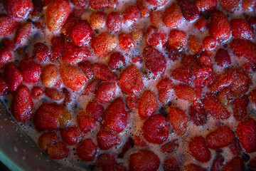 Blur background.Strawberry Berries in Jam. Cooking strawberry jam.