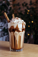 Coffee cocktail with whipped cream. Drink on table in cafe.