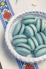 Blue turquoise macaroon. Sweet French dessert in basket.