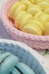 Blue and yallow macaroon. Sweet French dessert in basket.