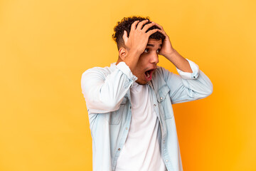 Young african american curly man isolated on purple screaming, very excited, passionate, satisfied with something.