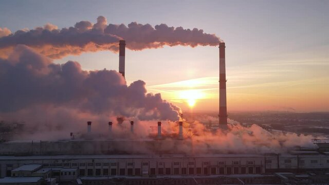 Smoking factory chimneys. Environmental problem of pollution of environment and air in large cities. View of large plant with Smoking pipes